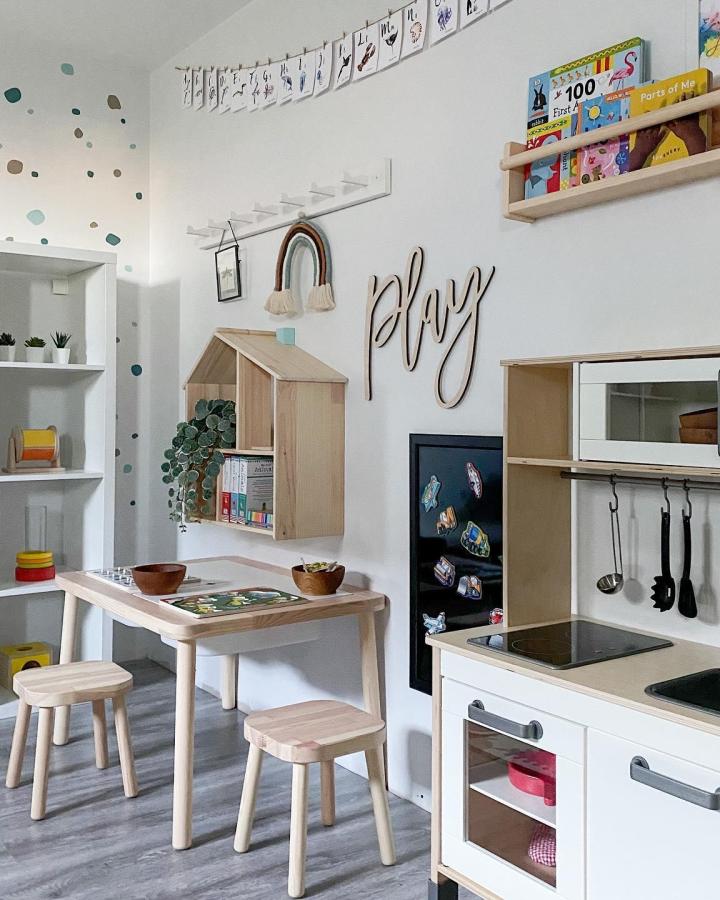 Natural wood playroom setup from @playroominspo featuring Flisat table and wall-mounted storage cubbies.