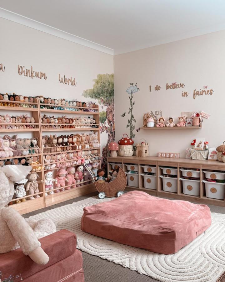 Natural wood Ikea Trofast storage system from @poppymae___. White canvas bins organize doll collection beautifully.