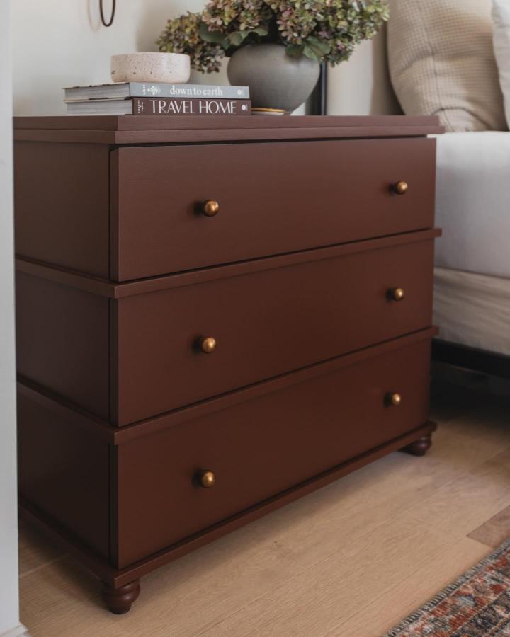 rich brown chest of drawers with brass knobs in cozy living space from @jennasuedesign ikea storage hacks & ideas with stylish storage solution
