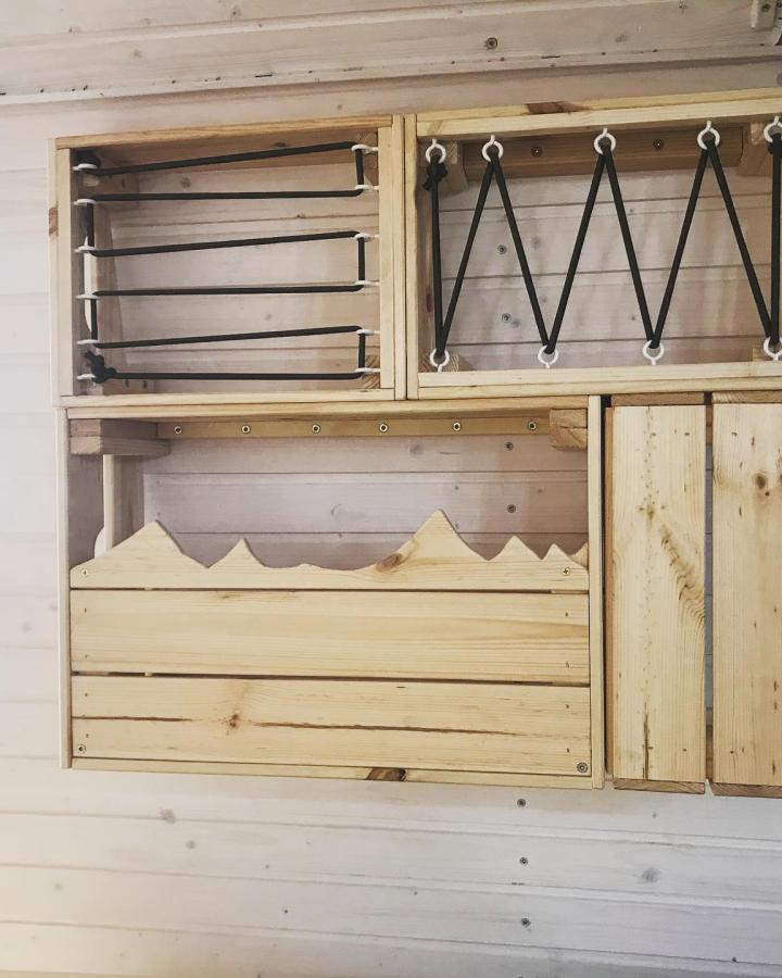 natural wood wall-mounted storage unit with elastic straps from @roffingaround designed for flexible organization and rustic charm ikea storage hacks & ideas