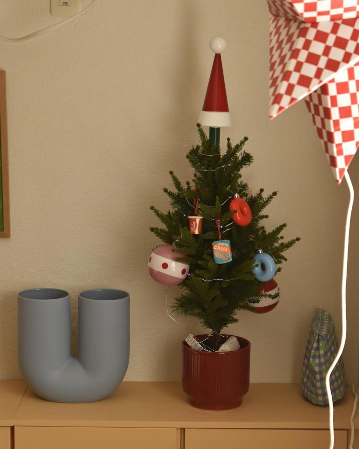 Miniature Christmas tree with colorful Vinterfint ornaments and Santa topper from @callistemon.house on wood shelf