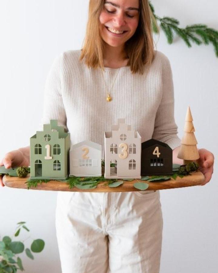 Painted advent houses displaying ikea vinterfint hacks & ideas from @schereleimpapier. Numbered 1-4 with eucalyptus on wood board.