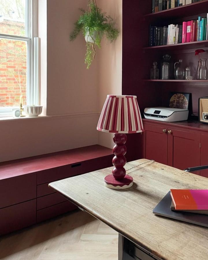 Burgundy reading nook with ikea window bench hacks & ideas from @heatheryounguk featuring Nordli drawers and matching shelving.