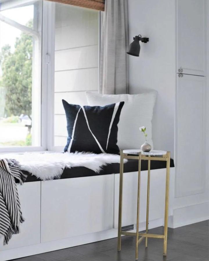 Monochrome window bench from Joyful Derivatives with black and white textiles and shiplap wall detail.