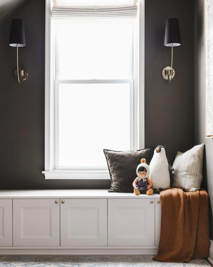 White built-in window bench showcasing ikea window bench hacks & ideas from Yellow Brick Home with charcoal walls.