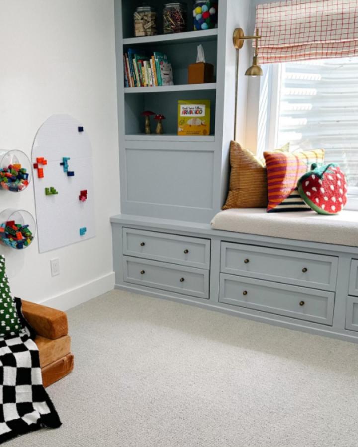 Gray built-in window bench from Sarah Flips It showcasing ikea window bench hacks & ideas with drawer storage below.