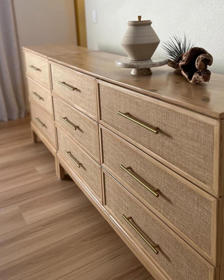 Natural burlap dresser from @beehivediys with brass handles and organic styling elements