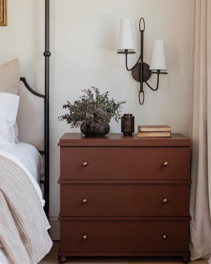 Rich chocolate-stained Ikea Malm dresser from @jennasuedesign showcasing restoration hardware hacks & ideas with brass hardware and bun feet.