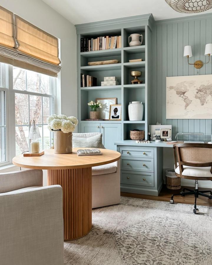 soft blue built-in bookshelf and desk with woven chair in cozy home office from @homeonharbor comfortable reading nook with window light
