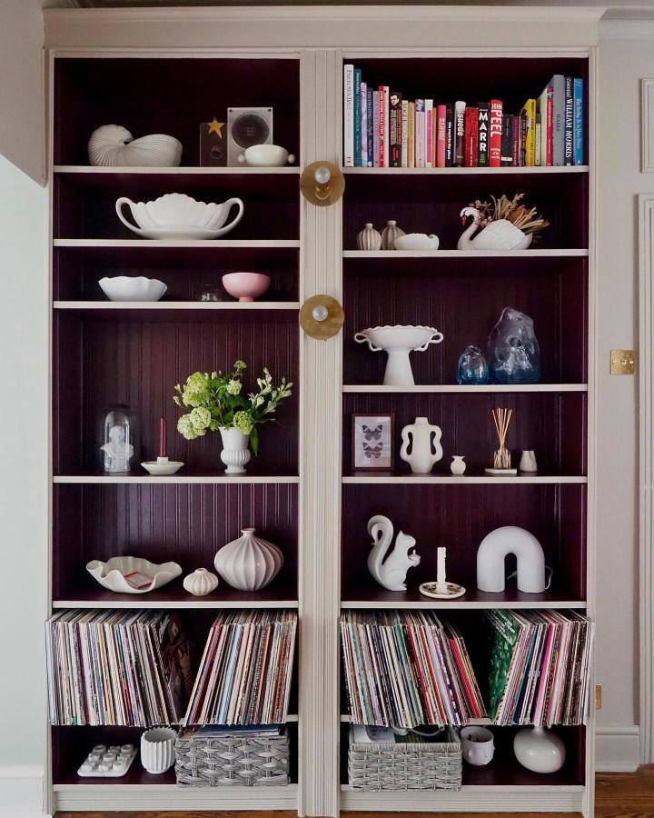 dark purple and cream painted Ikea Billy bookcase from @melanielissackinteriors with ceramics and records neatly arranged