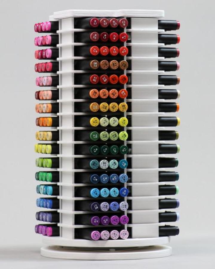 White rotating marker tower from Stamp n Storage. Organized markers arranged by color for ikea craft room storage hacks.