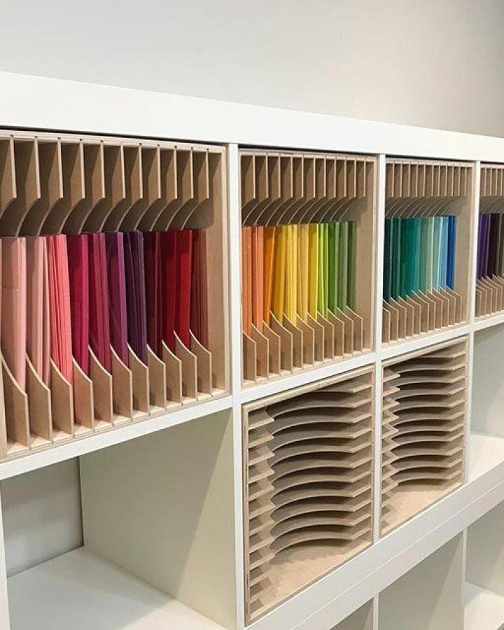 Natural wood and white IKEA shelving with colorful paper storage dividers from @onecraftysister perfect for ikea craft room storage hacks.