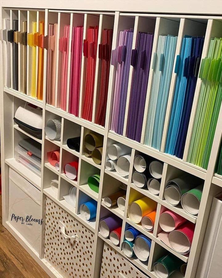 White modular storage unit with neatly color-coordinated paper folders and rolled craft materials from @smartfundiy showing ikea craft room storage hacks.