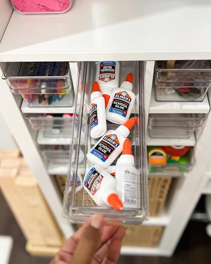 Clear plastic drawer inserts for organized craft glue storage from @polishedplayhouse. Easy access and neat Ikea craft room storage hacks.