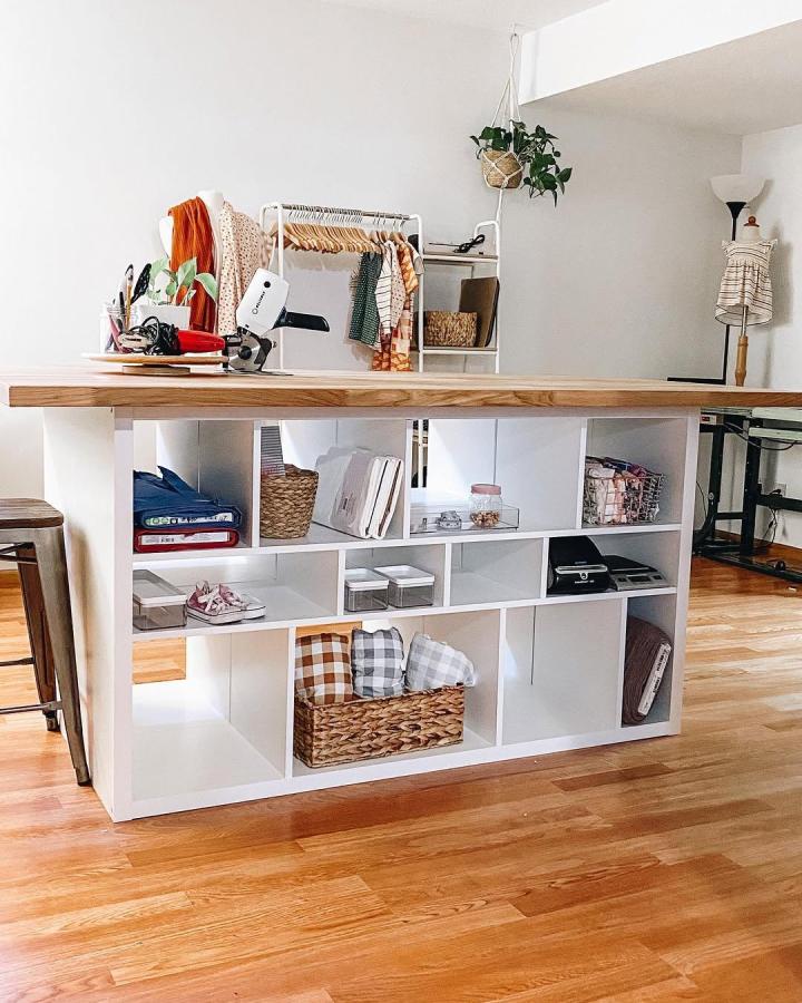white and wood craft table with ikea kallax craft table hacks storage cubes and baskets in bright craft room