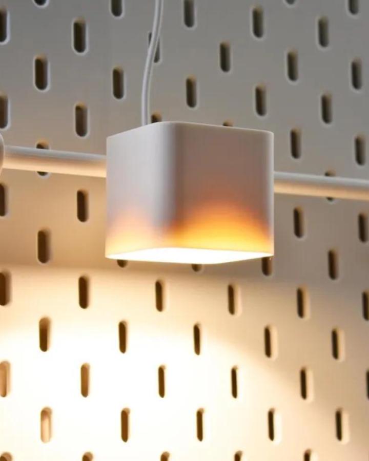 white cube light on beige ikea skadis pegboard wall close-up showing ikea skadis pegboard craft room hacks from TokkiWorkshop