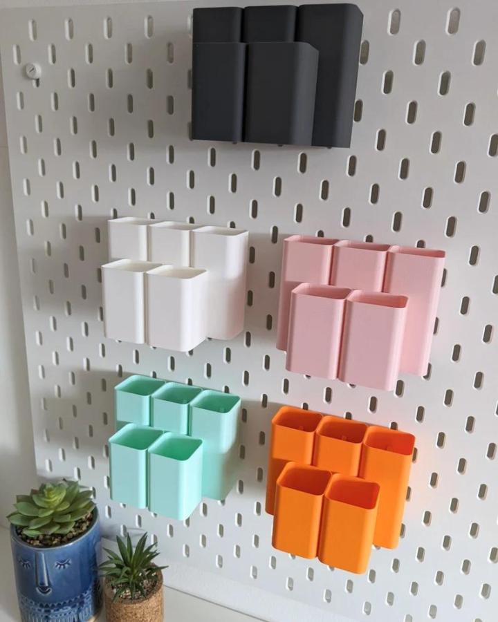 Colorful modular containers on a white Ikea Skadis pegboard for craft room storage by 3DShrimping.