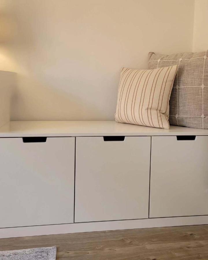 white matte Ikea Nordli storage bench with cushions from @ourlittle_place minimal sleek design ikea storage hacks & ideas