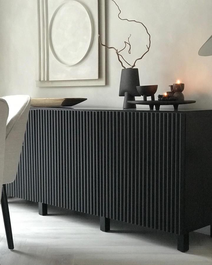 charcoal textured fluted Ikea Besta sideboard from @our_home_interior_3 featuring modern sculptural decor and minimalist wall art
