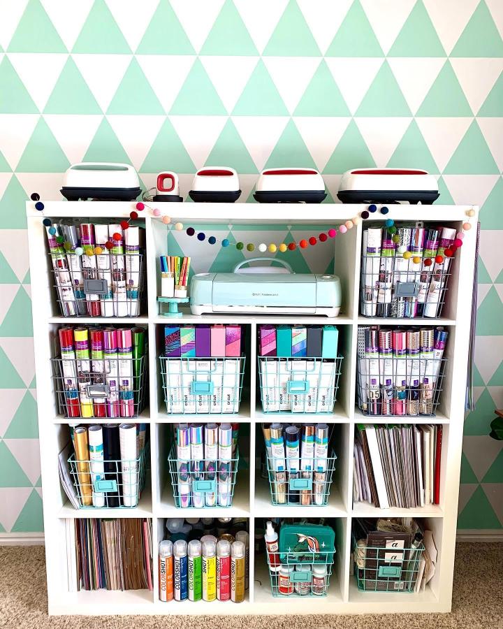 White Ikea Kallax shelf with pastel-colored wire baskets and organized craft supplies from @everyday.jenny showing ikea cricut storage ideas.