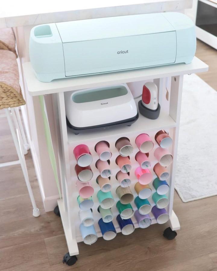 White Ikea Raskog cart with pastel vinyl rolls for ikea cricut storage ideas from @homesweetpink in cozy craft room.