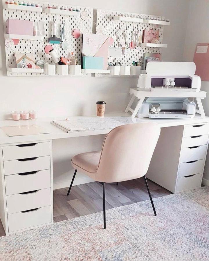 White Ikea Alex drawers and Linnmon desk top craft workspace from @lovedbyhayley with pegboard and organized cricut materials