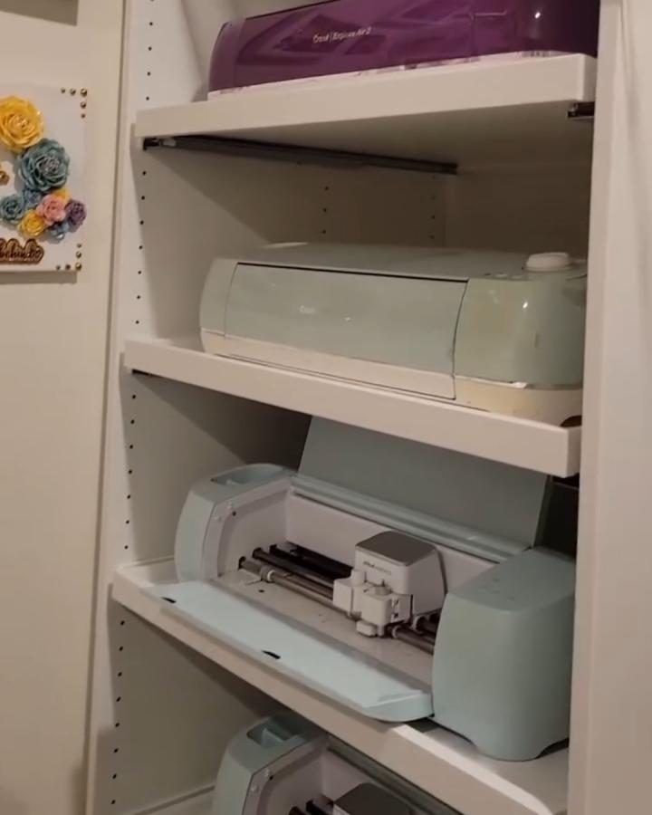 White Ikea Pax with sliding drawers craft storage from @truepaperlove. Neatly organized Cricut machines on shelves. ikea cricut storage ideas.