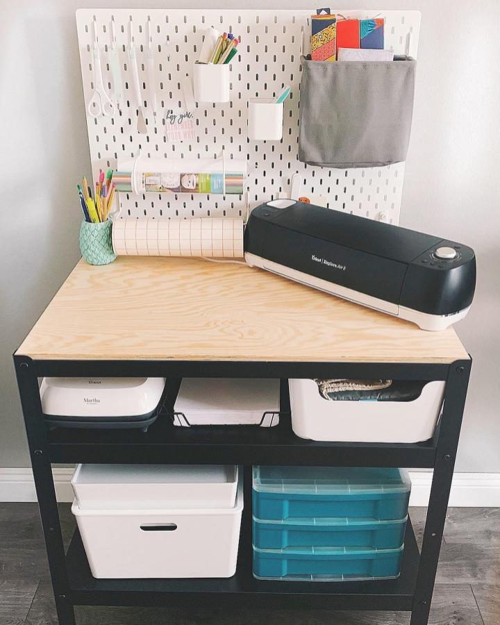 White Ikea Skadis pegboard with storage cups and Fjallbo shelving from @spedadulting ideal for ikea cricut storage ideas.