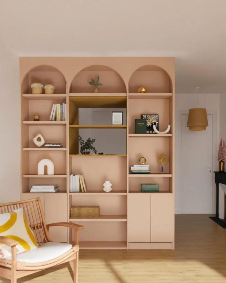 Dusty rose Ikea Platsa update unit with arched shelves and warm wood accents from @madamemaisonnette in a cozy living room setup.