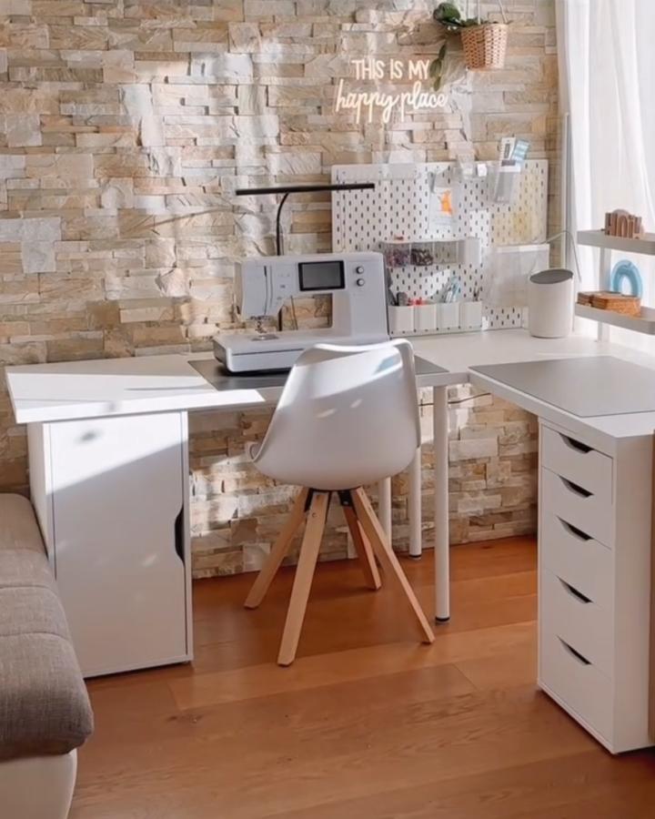 Bright white Ikea Alex desk and Skadis pegboard sewing room setup from @hoi_handmade_inthealps with cozy brick wall and neat storage ikea sewing room hacks & ideas