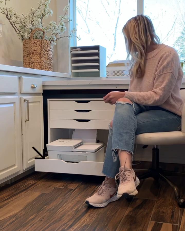 White Ikea Alex desk with custom pull-out drawer storing a printer under a countertop from @fancyfixdecor. Practical workspace organization idea.