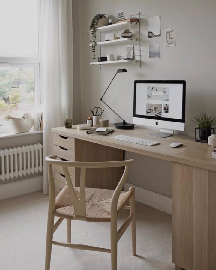 Soft natural wood desk with Ikea Alex drawers and minimal wall shelves from @thesefourwallsblog in a cozy home office setting.