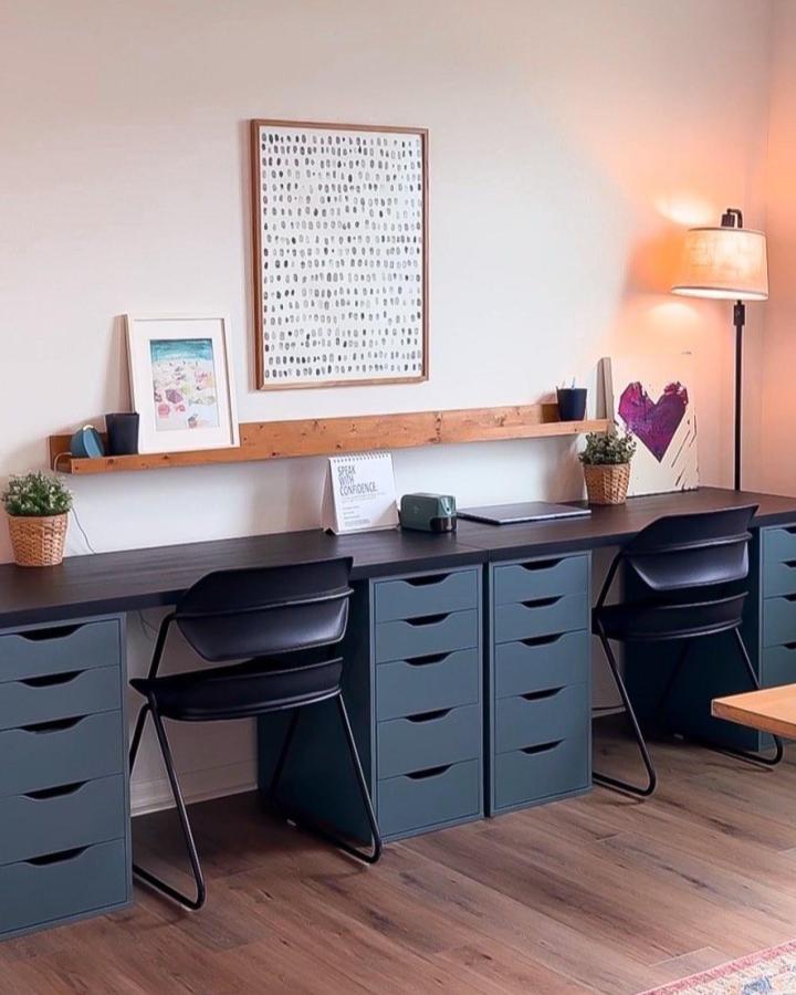 Matte blue Ikea Alex drawer units with dark wood tabletop and simple shelf from @tabletopfamily in modern workspace.