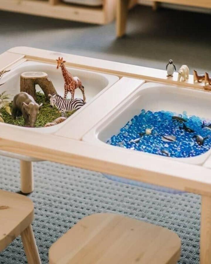 Natural pine sensory table from Joseph Hamby with dual bins for tactile play featuring safari and water themes in ikea flisat table hacks & ideas.