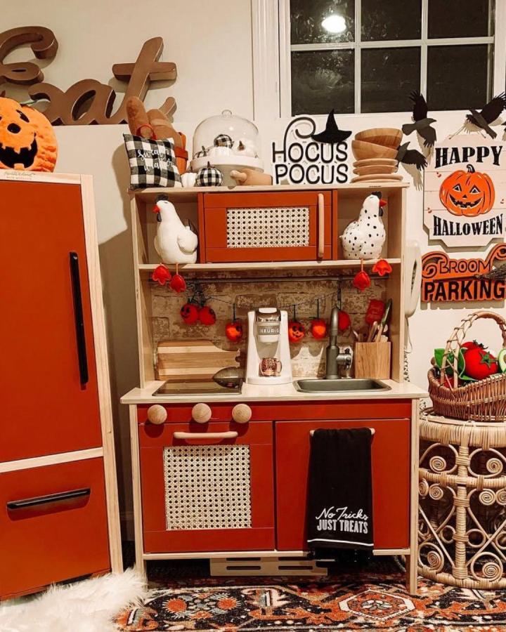 Burnt orange and natural rattan Ikea flisat table kitchen hack from @makeitwithmicah with autumnal cozy playroom style.