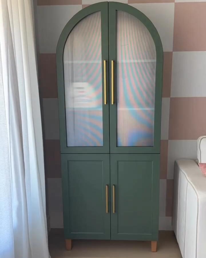 Green arched door Ikea Kallax makeover ideas cabinet with brass handles and wooden feet from @parkplaceabode. Elegant and modern storage solution.