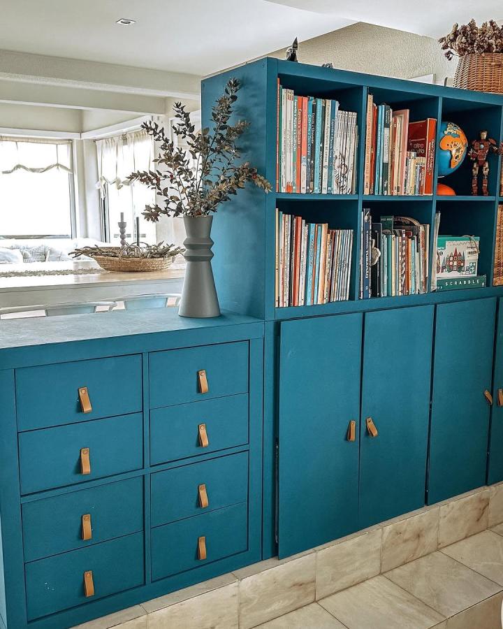 Bold blue ikea kallax makeover ideas with leather pulls from @ossalemas showing elegant storage and shelving transformation.