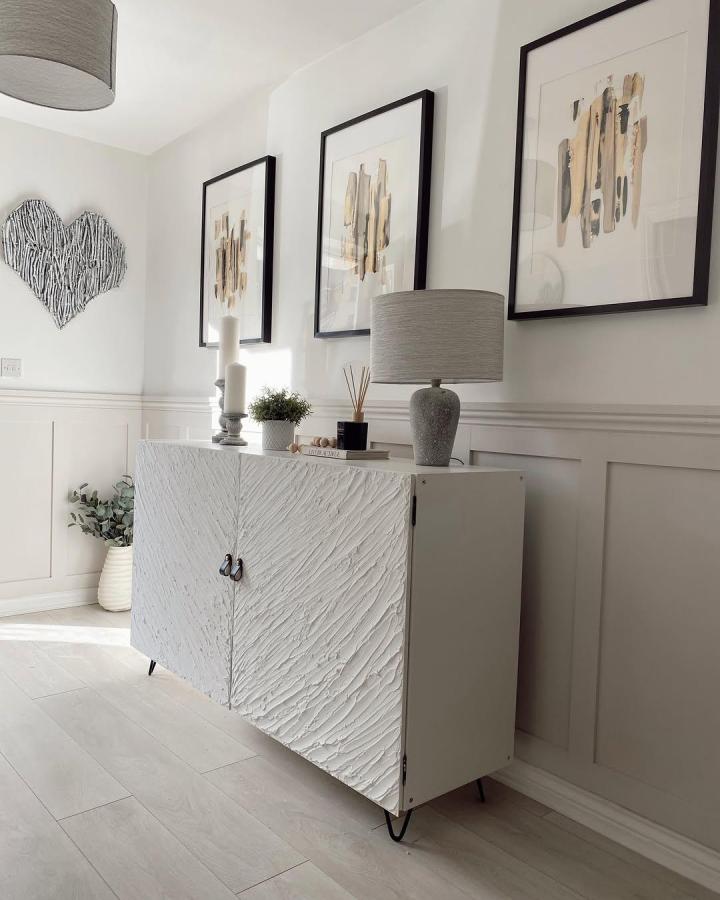 White textured Ikea Kallax makeover ideas cabinet with black hairpin legs in a bright living room from @elocin_home.