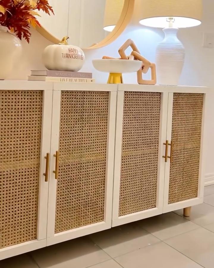 White-framed ikea kallax makeover ideas with woven cane door panels and brass handles by @thequeentonie in a bright room.