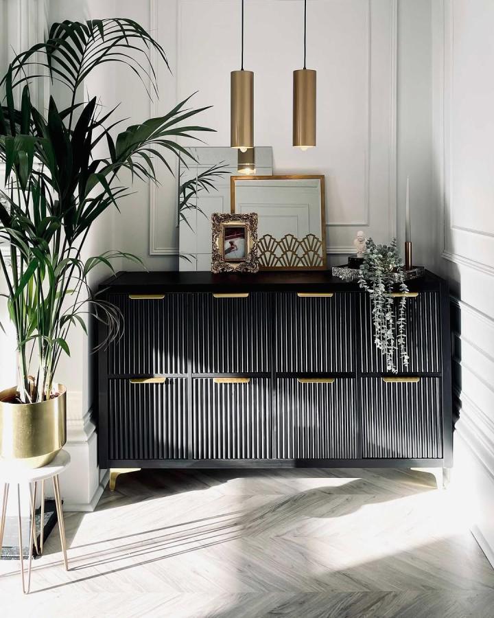 Black textured ikea kallax makeover ideas sideboard with gold handles and decorative plants in bright room from @mysecrethouseaccount.