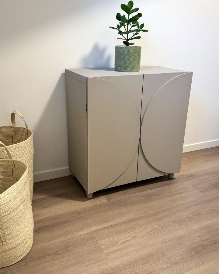 Curved beige sculptural door ikea kallax makeover ideas with plant on top from @homeinspiration_bymt.