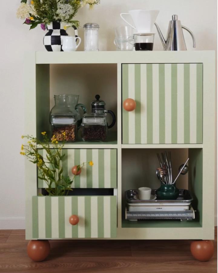 Green and white striped Ikea kallax makeover ideas with terracotta knobs and wooden ball feet from @prettypegs kitchen storage unit