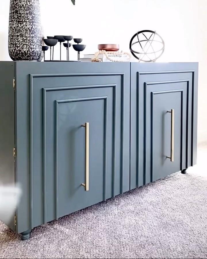 Slate blue paneled Kallax cabinet with brass handles on carpeted floor from @liveandgatherco showing smart ikea kallax makeover ideas.
