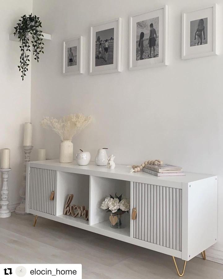 White minimalist Ikea Kallax styling ideas sideboard with textured slatted doors, brass legs, and soft decor from @ikeahackersofficial.