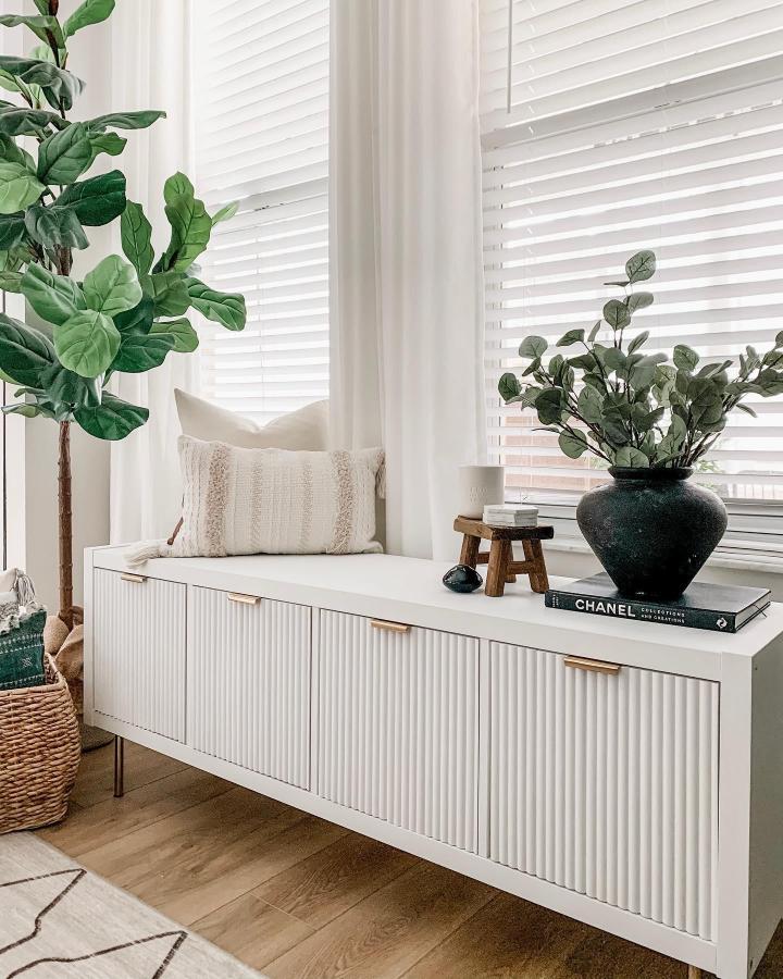 White shiplap door ikea kallax styling ideas cabinet with metal handles and wood legs from @xomyhome. Modern clean living room storage setup.