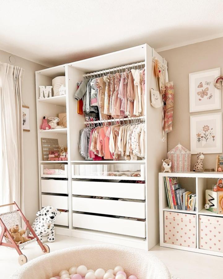 white double-rod kids wardrobe with drawers and hooks from @hausnummereinszwei neat ikea kids wardrobe ideas in soft pastel colors