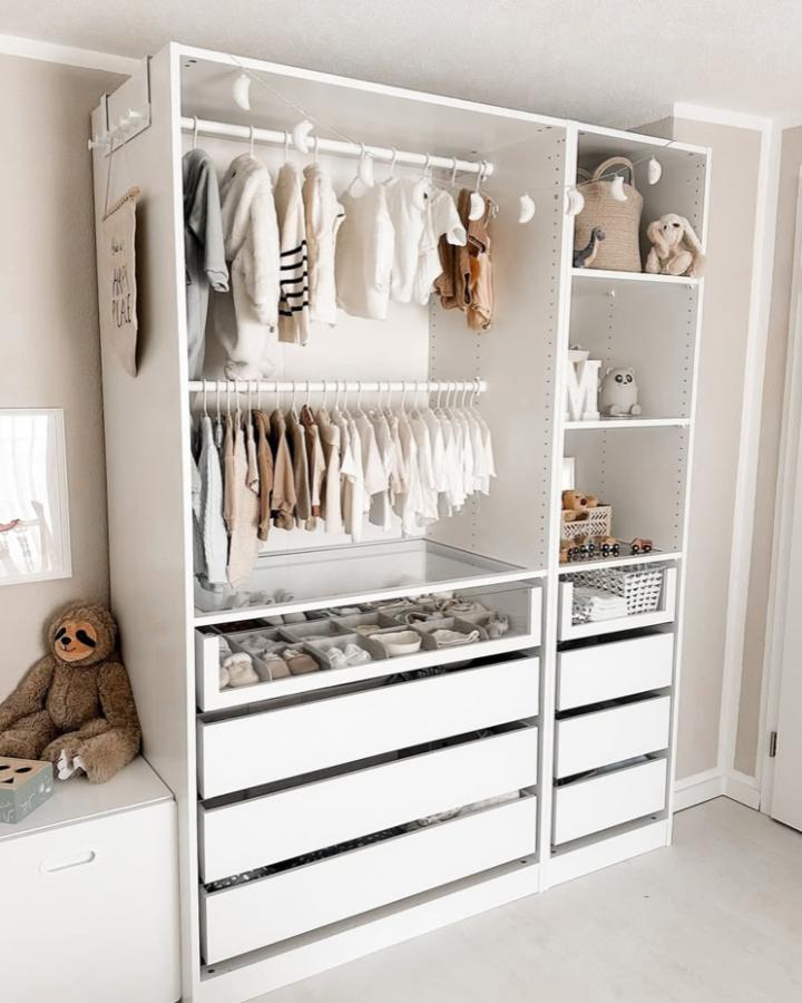 White minimalist kids wardrobe with clear drawer fronts and hanging rods from @hausnummereinszwei perfectly organized with soft neutral clothes and tiny shoes ikea kids wardrobe ideas