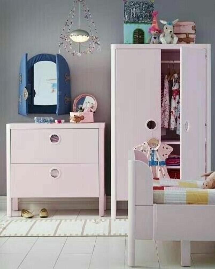 Soft pink kids wardrobe and dresser with circular cutouts from @ikeasverige featuring playful and practical ikea kids wardrobe ideas.