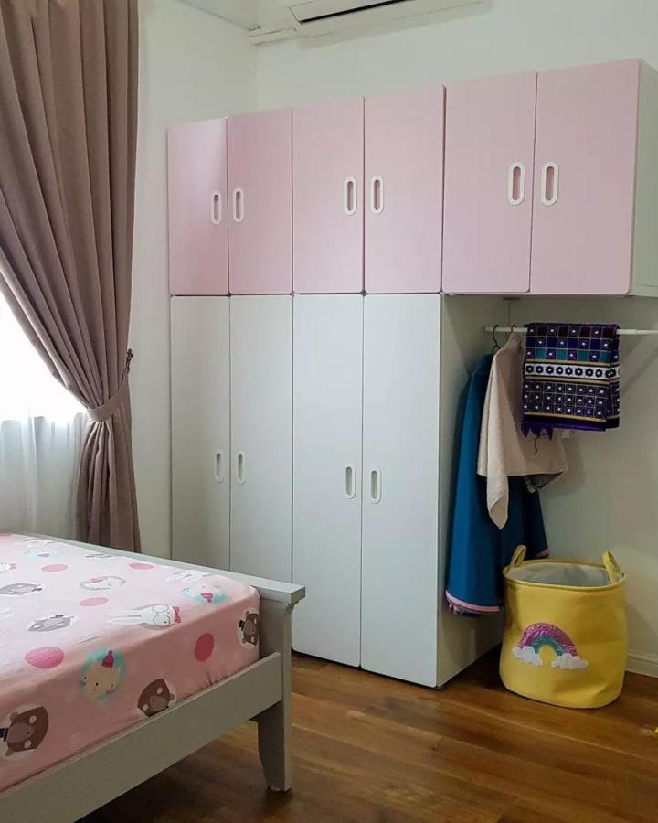 Pink and white two tone Ikea kids wardrobe ideas with custom handle cutouts and hanging space from @rumah.haslinda in a bright kids bedroom.