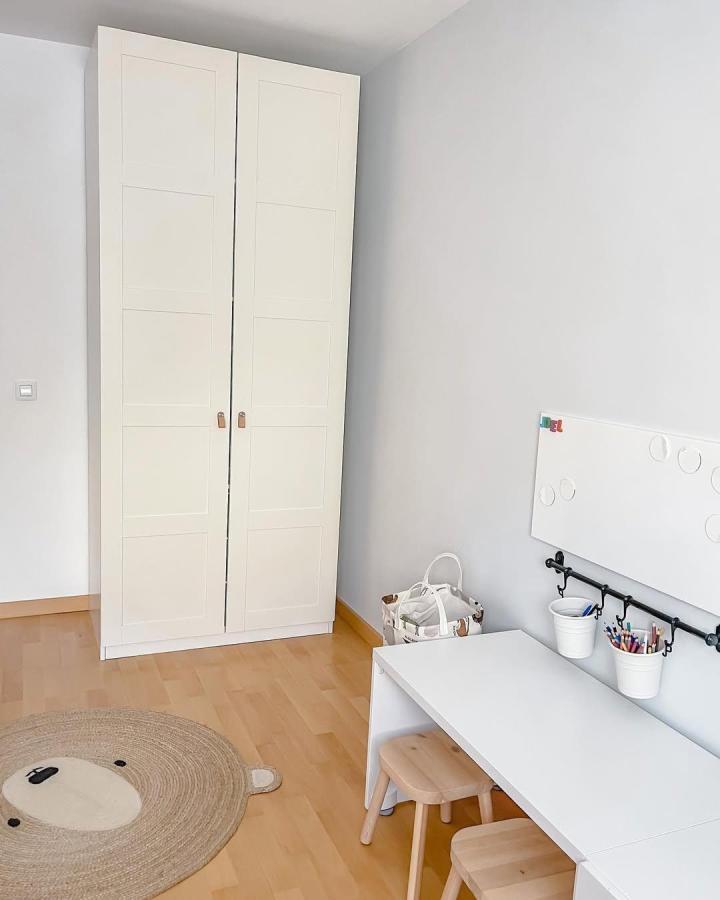 White minimalist wardrobe with leather handles in a child’s room by @marianordichouse simplicity meets practicality in ikea kids wardrobe ideas